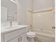 Clean bathroom featuring a shower-tub combo, updated vanity, hardware, and bright lighting at 823 Kokomo Cir, Port Orange, FL 32127