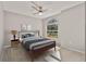 Cozy staged bedroom with a large window, area rug, and neutral-toned decor at 823 Kokomo Cir, Port Orange, FL 32127