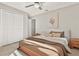 Staged bedroom with light-colored walls, neutral decor, ceiling fan, and closet at 823 Kokomo Cir, Port Orange, FL 32127