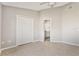 Bright bedroom features neutral tones, closet, and doorway leading to an ensuite bathroom at 823 Kokomo Cir, Port Orange, FL 32127