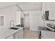 Well lit kitchen with stainless steel appliances, white cabinets and quartz countertops at 823 Kokomo Cir, Port Orange, FL 32127