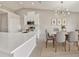 Modern kitchen with white cabinetry, stainless steel appliances, and an adjacent dining area at 823 Kokomo Cir, Port Orange, FL 32127