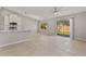 Bright living space featuring tile floors, modern ceiling fan, and sliding glass doors to the backyard at 823 Kokomo Cir, Port Orange, FL 32127