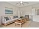 Comfortable living room with a neutral color palette, a ceiling fan, and ample seating at 823 Kokomo Cir, Port Orange, FL 32127