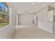 Living room showcases tile flooring, neutral paint, modern lighting, and open layout to the kitchen at 823 Kokomo Cir, Port Orange, FL 32127