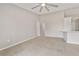 Spacious living area with tile floors and neutral walls, adjacent to kitchen area and hallway at 823 Kokomo Cir, Port Orange, FL 32127