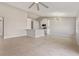 Open-concept living room and kitchen with tile flooring, white cabinets, and modern light fixture at 823 Kokomo Cir, Port Orange, FL 32127