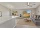 Modern living room with an open layout, a ceiling fan, and sliding glass doors to the backyard at 823 Kokomo Cir, Port Orange, FL 32127