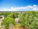 Scenic aerial view captures a lush neighborhood featuring mature trees at 11512 Grand Bay Blvd, Clermont, FL 34711