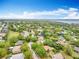 This aerial view displays community near the lake, with lush greenery and mature trees at 11512 Grand Bay Blvd, Clermont, FL 34711