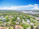 Aerial view displays community near the lake, with lush greenery and beautiful skyline at 11512 Grand Bay Blvd, Clermont, FL 34711
