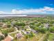 An elevated view of a residential neighborhood with homes, streets, and lush green landscaping under blue sky at 11512 Grand Bay Blvd, Clermont, FL 34711