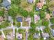 An aerial view shows neatly arranged homes within the community, interspersed with mature trees at 11512 Grand Bay Blvd, Clermont, FL 34711