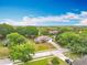 An elevated view showcases a home with a long drive in a neighborhood with green trees at 11512 Grand Bay Blvd, Clermont, FL 34711