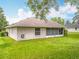 A charming single-story home offers a backyard with a well-maintained lawn at 11512 Grand Bay Blvd, Clermont, FL 34711