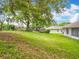 Expansive backyard featuring lush green grass, mature trees and a shed offering privacy at 11512 Grand Bay Blvd, Clermont, FL 34711