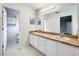 Well-lit bathroom featuring double sinks, a large mirror, and ample storage space for convenience at 11512 Grand Bay Blvd, Clermont, FL 34711