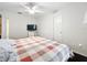 Bright bedroom featuring a television and a double bed with a checkered comforter at 11512 Grand Bay Blvd, Clermont, FL 34711
