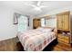 Bedroom featuring a double bed with a checkered comforter and a built in headboard at 11512 Grand Bay Blvd, Clermont, FL 34711