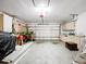 Spacious garage featuring built-in cabinets, overhead door, and ample room for parking and storage at 11512 Grand Bay Blvd, Clermont, FL 34711