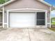 Attached single car garage showcasing a well-maintained door and convenient side entry at 11512 Grand Bay Blvd, Clermont, FL 34711
