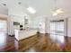 Bright kitchen boasts white cabinetry, a center island with marble counters, and stainless steel appliances at 11512 Grand Bay Blvd, Clermont, FL 34711