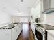 Modern kitchen offers an island with marble countertops, stainless steel appliances, and wood floors at 11512 Grand Bay Blvd, Clermont, FL 34711