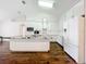 Modern white kitchen with stainless steel appliances, granite countertops and spacious island at 11512 Grand Bay Blvd, Clermont, FL 34711