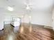 Open living room with hard floors, fan, and view to the kitchen at 11512 Grand Bay Blvd, Clermont, FL 34711