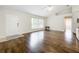 Bright living room with hard floors, fan, and large window at 11512 Grand Bay Blvd, Clermont, FL 34711