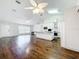 Open-concept living room featuring hardwood floors and a seamless transition to the kitchen at 11512 Grand Bay Blvd, Clermont, FL 34711