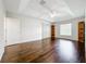 Bright main bedroom with hardwood floors, tray ceiling, and built-in bookcase at 11512 Grand Bay Blvd, Clermont, FL 34711