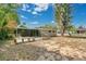 Backyard with deck surrounded by mature trees and landscaping at 1203 Judy Ave, Tavares, FL 32778