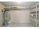 Unfinished basement with water heater and built in shelves at 1203 Judy Ave, Tavares, FL 32778