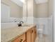 Bathroom with granite countertop, wood cabinetry, and modern toilet at 1203 Judy Ave, Tavares, FL 32778