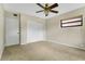 Inviting bedroom with carpet, large closet, and ceiling fan at 1203 Judy Ave, Tavares, FL 32778
