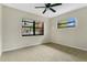 Bright bedroom featuring neutral carpet and two windows that let in ample light at 1203 Judy Ave, Tavares, FL 32778