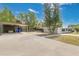 Spacious driveway and carport lead to the single-story home and fenced backyard at 1203 Judy Ave, Tavares, FL 32778