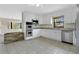 Bright kitchen with stainless steel appliances, granite countertops, and tile flooring at 1203 Judy Ave, Tavares, FL 32778