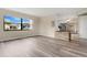 Open-concept living area with new flooring, natural light, and a view to the kitchen at 1203 Judy Ave, Tavares, FL 32778