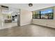 Bright living room featuring wood floors, large window, and view to the kitchen at 1203 Judy Ave, Tavares, FL 32778