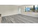 Inviting living room with light-colored flooring, a ceiling fan, and natural light at 1203 Judy Ave, Tavares, FL 32778
