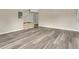 Neutral living space with laminate floors and a brick accent feature at 1203 Judy Ave, Tavares, FL 32778