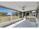 Covered porch featuring an overhead fan and views of the manicured yard at 1203 Judy Ave, Tavares, FL 32778