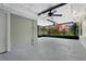 Enclosed sun room featuring a ceiling fan and exterior views of blooming plants at 1203 Judy Ave, Tavares, FL 32778