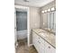 Bright bathroom featuring a granite countertop vanity and tiled shower and tub at 126 Maitland Ave # 126, Altamonte Springs, FL 32701