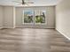Large bedroom features updated floors, modern ceiling fan and a picturesque window view of the outdoors at 126 Maitland Ave # 126, Altamonte Springs, FL 32701