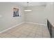 Open concept dining room with view to the kitchen, tile flooring, and modern light fixture at 126 Maitland Ave # 126, Altamonte Springs, FL 32701