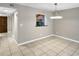 Inviting dining area with view to the kitchen, tile flooring, and modern pendant lighting at 126 Maitland Ave # 126, Altamonte Springs, FL 32701