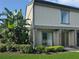 Inviting townhouse featuring well-maintained landscaping, mature plants, and a neutral-colored exterior at 126 Maitland Ave # 126, Altamonte Springs, FL 32701